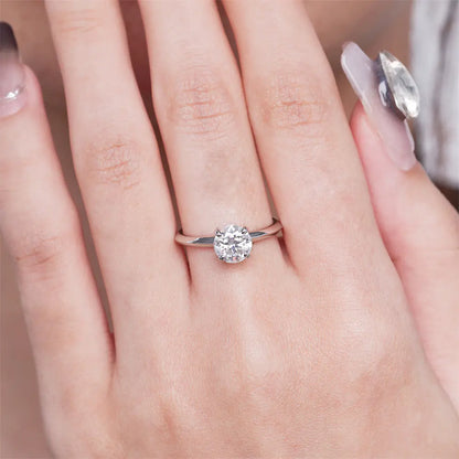 1 carat moissanite solitaire ring worn on a finger