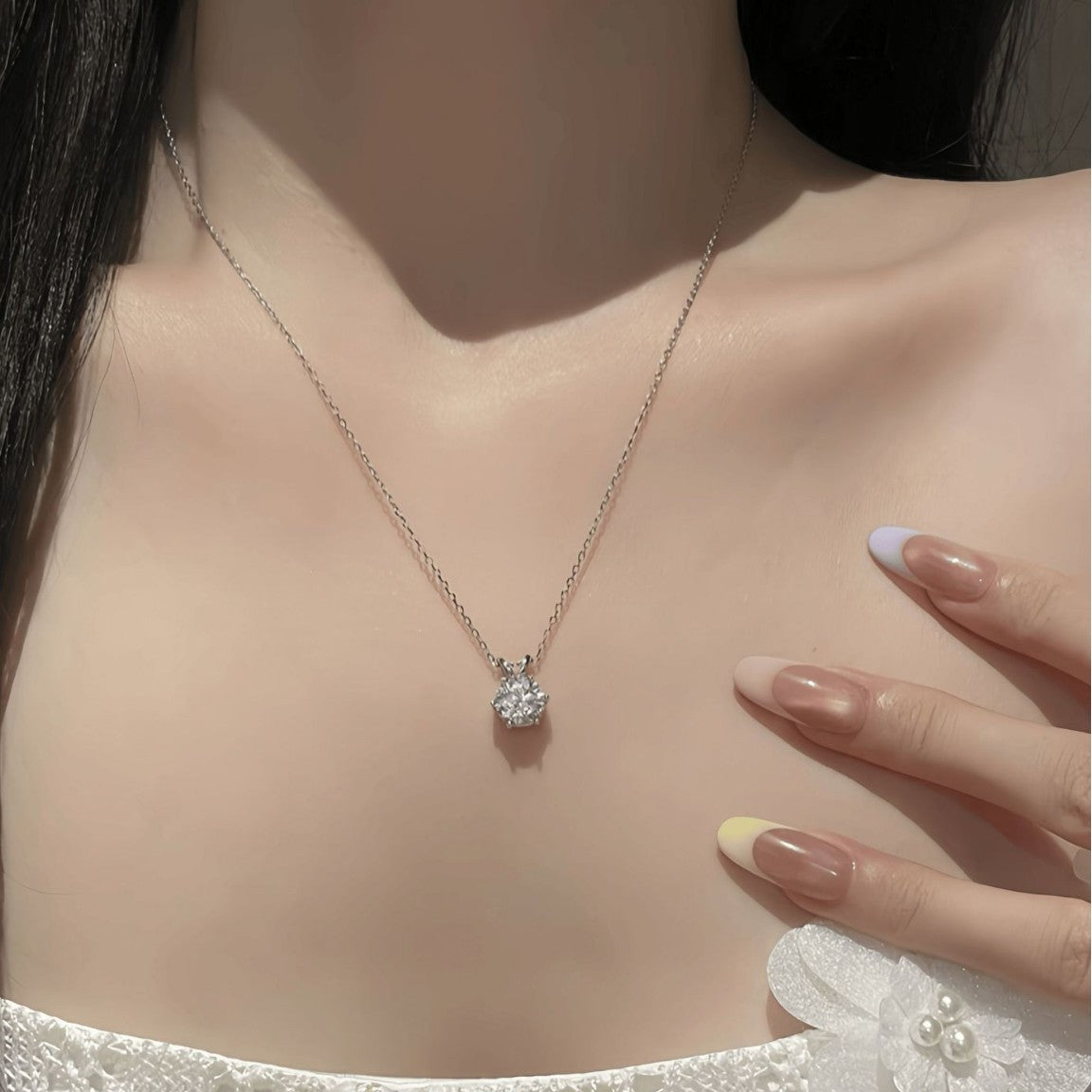 Six-prong moissanite solitaire pendant necklace worn around the neck